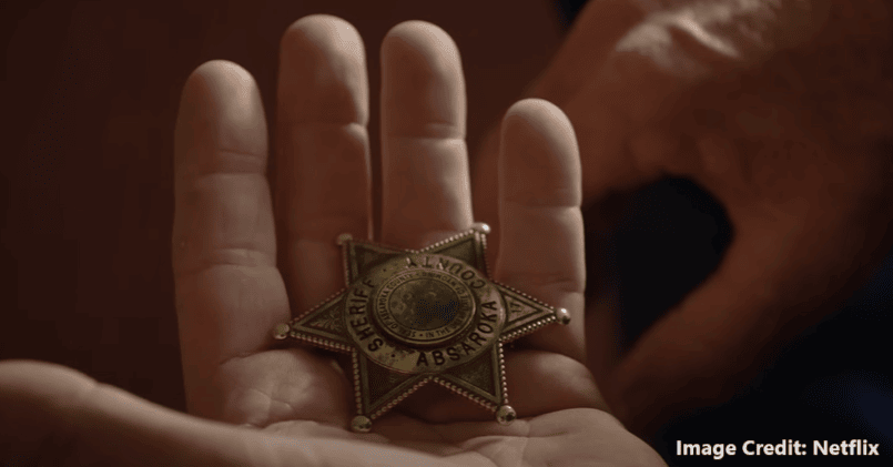 Sherrif County badge holding in hand - Longmire - Netflix