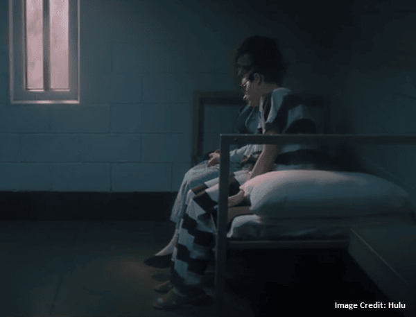 Gypsy resting her head on Dee Dee in cell - The Act Miniseries - Hulu