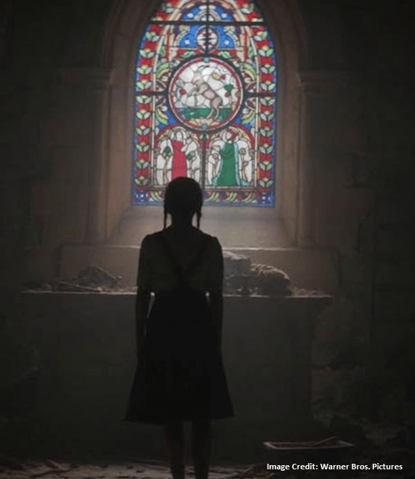 Sophie in front of goat in the glass pointing to Saint Lucy's Eyes - The Nun 2 - Warner Bros. Pictures